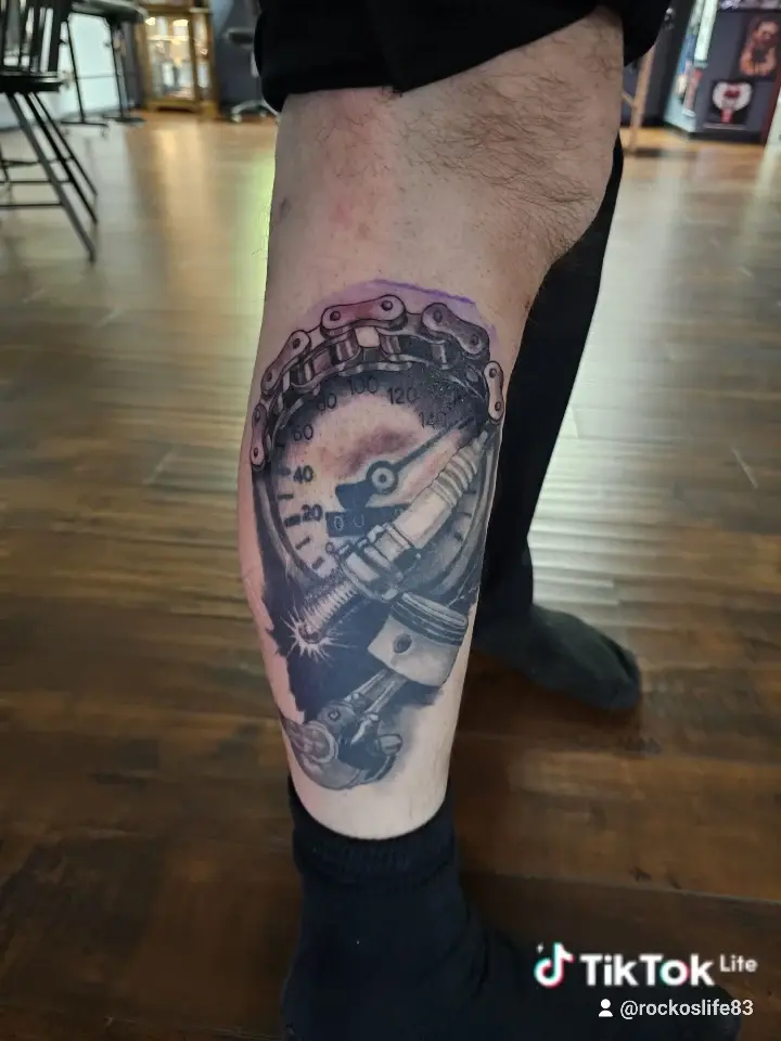 Black and gray skull and clock realism tattoo on a calf
